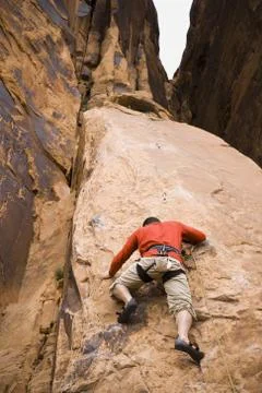 Man climbing mountain Stock Photos