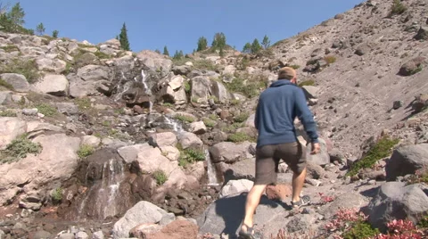Man Climbing Mountain Waterfalls Stock Footage 41769745