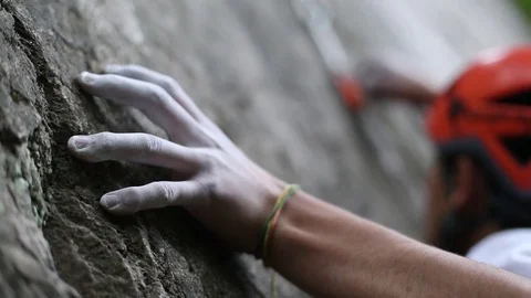 Rock climbers on a rock wall closeup. Climbing gear and equipment