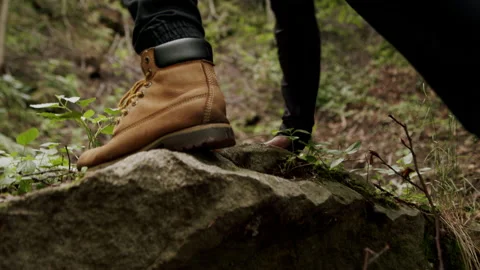 Man climbing on rocks while hiking in the forest, difficult trail slow-motion. Stock Footage 234552449