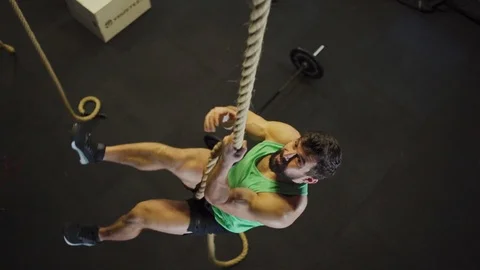 Man climbing rope in twinking light Stock-Footage 124860077