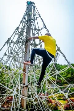 Man climbing the ropes Stock Photos