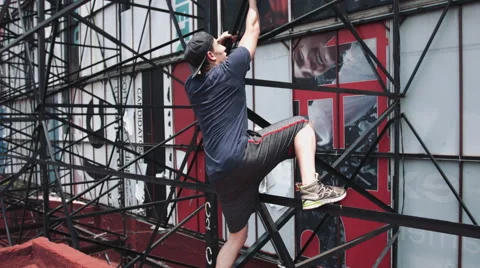 Man climbing on scaffolding Stock Footage 52194909