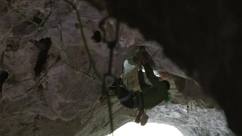 Man Climbing Up the Side of a Mountain Stock Footage 266804094