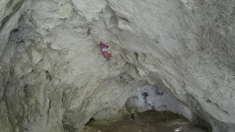 Man Climbing Up the Side of a Mountain Stock Footage 266912368