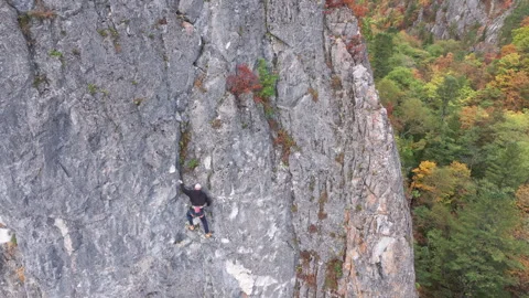 Man Climbing Up the Side of a Mountain Video stock 266915879