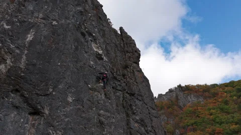 Man Climbing Up Side of Mountain Stock Footage 266917834