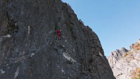 Man Climbing up the Side of a Mountain Stock-Footage 266924729