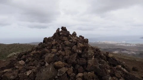 Man climbing the stack of rocks on volcanic landscape Stock Footage 71552965