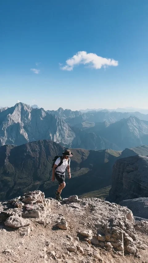 Man Climbing Toward Mountain Summit 動画素材 329775862