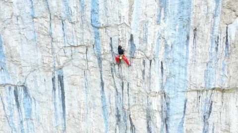 Man climbing on very steep mountain cliff wall outdoors rock climbing. Stock Footage 150555428