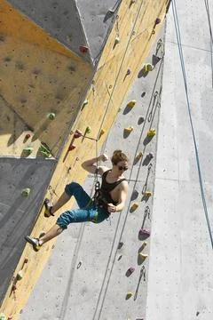 Man climbing up the wall Stock Photos