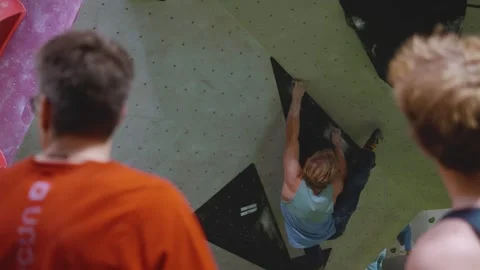 A man climbs on a bouldering wall Stock Footage 297598027