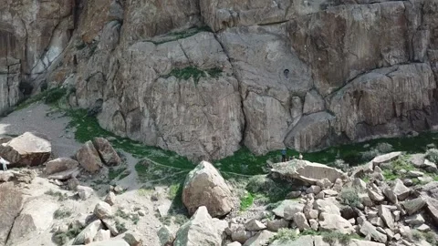 A man climbs up the cliff. Active leisure and sports. Video stock 155199398