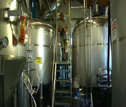 Man climbs down from large industrial equipment Video stock 21589574