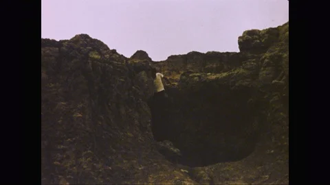 Man climbs down the rocks Badlands, USA, 1953 Stock Footage 125836779