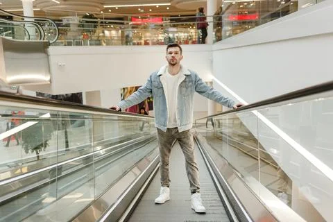 Man climbs on an escalator Stock Photos