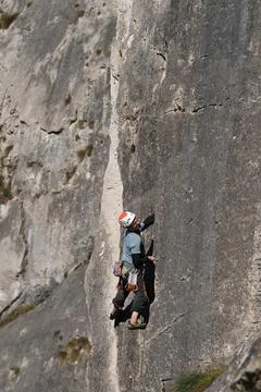 Man climbs limestone wall Stock Photos