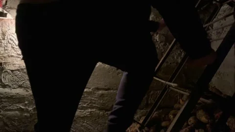 A man climbs out of the underground basement Stock Footage 162927627