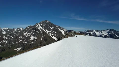 A man climbs the peak of a mountain in winter with a view of the fjord Stock Footage 222946613