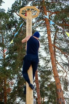 A man climbs on a pillar at Shrovetide Stock Photos