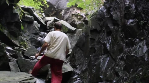 Man climbs rocks Stock Footage 41978138