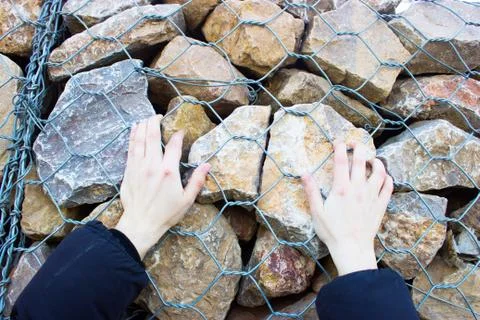 A man climbs the rocks Stock Photos