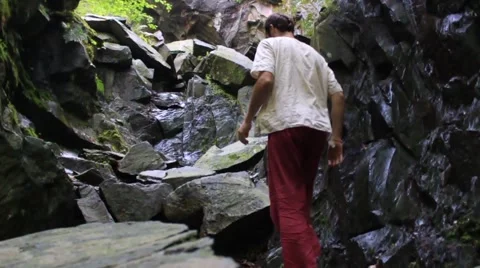 Man climbs rocks in slow motion Stock Footage 41987450