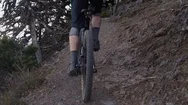 Man Climbs Up Rocky Trail On His Mountain Bike On Orcas Island Stock Footage