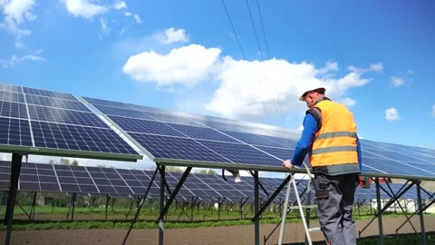 Man climbs a stepladder to solar panels. Stock Footage 168178508