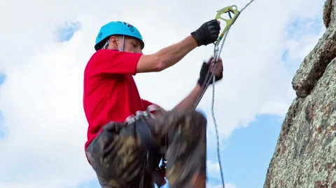 Man climbs up on top of the rock Stock Footage 40617598
