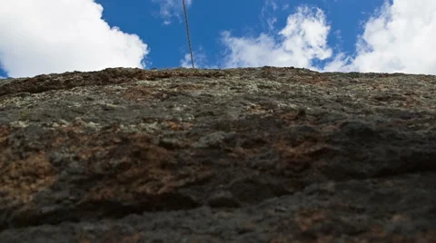 Man climbs up on top of the rock Stock Footage 40617661