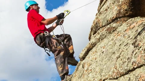 Man climbs up on top of the rock Stock Footage 40617700