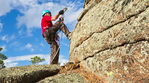 Man climbs up on top of the rock Stock Footage 40617860