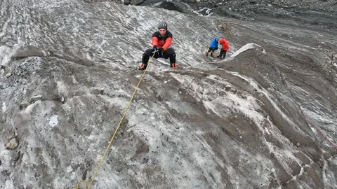 A man climbs uphill on a vertical railing on a jumar. Ice activities Stock-Footage 208438225