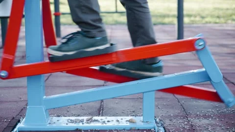 A man climbs onto a walking simulator and begins the exercise Stock Footage 241434137