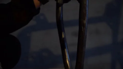The man clings to the mass for welding. Work in the garage Video stock 124360720