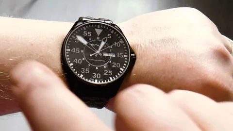 Man with a clock on his hand Stock Footage 78305980