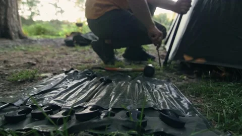 Man clogs rods - camping tent near the lake Stock Footage 207431218