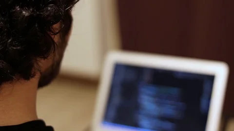 Man close-up coding on laptop with blurry screen. Programming and developing Stock Footage 121582078