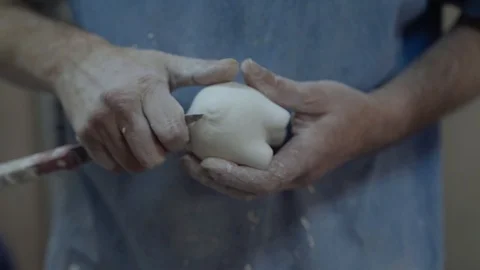 A man close-up makes a children's toy from plaster Stock Footage 102258588