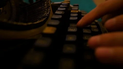 Man close-up prints on an old typewriter slowly Stock Footage 93663905