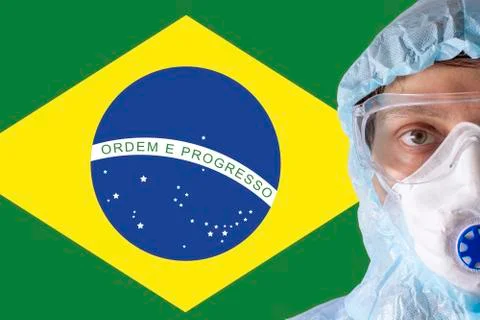 Man close-up in white protective suit, mask, glasses and gloves on the Stock Photos