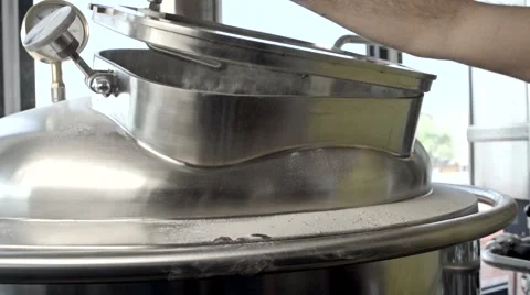 Man closes the brewing container with water splashes Stock Footage 64919804