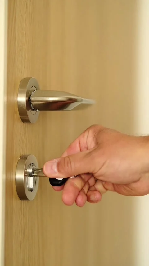 The man closes the door and locks it with a key Stock Footage 279983269