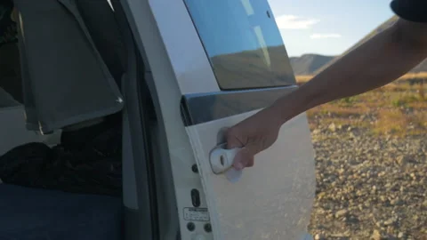 A man closes the door of his van before hitting the road, in New Zealand Stock Footage 217011013
