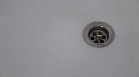 The man closes the drain in the bath and turns the water on Stock Footage 60343017
