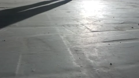 Man closes the gate, shadow on the concrete floor. Stock Footage 136022599