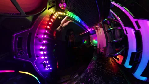 A man closes the glass side panel of a gaming PC as the camera pulls back, Stock Footage 289792293