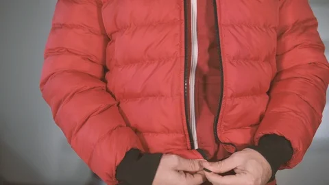 Man closes his winter jacket Stock Footage 123474129